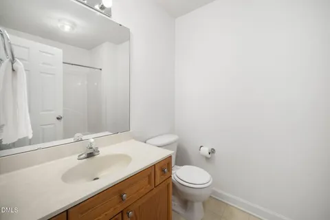 a bathroom with a toilet a sink and a window