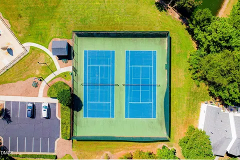 an aerial view of a pool patio and lake view