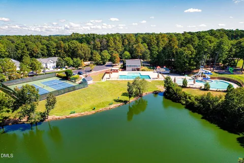an aerial view of a house with a yard and swimming pool