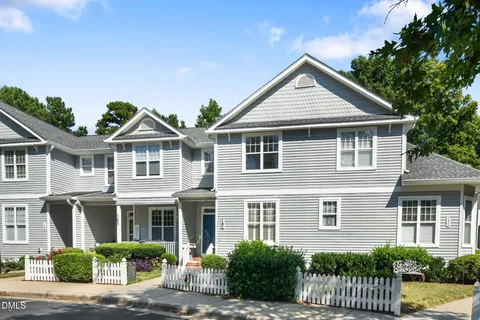 an aerial view of a chairs and table with swimming pool