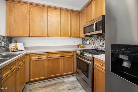 a kitchen with a sink cabinets and window