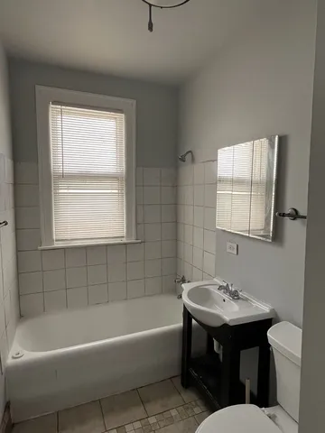 a bathroom with a sink bathtub and a toilet