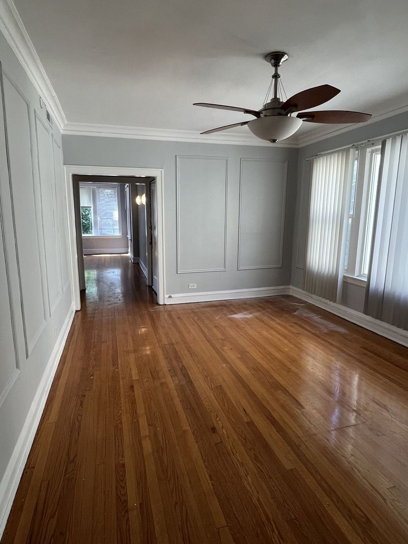 8019 South Vernon Avenue, Unit 2 Chicago, IL 60619 - Photo 8 of 13 wooden floor in an empty room with a window