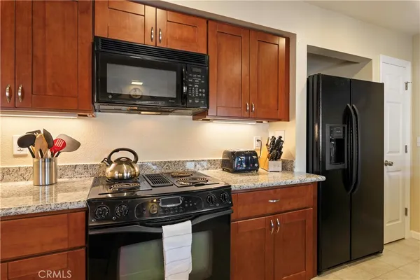 a kitchen with stainless steel appliances wooden cabinets and a stove top oven
