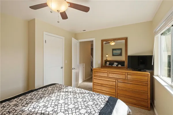 a bedroom with a bed and a dresser in it