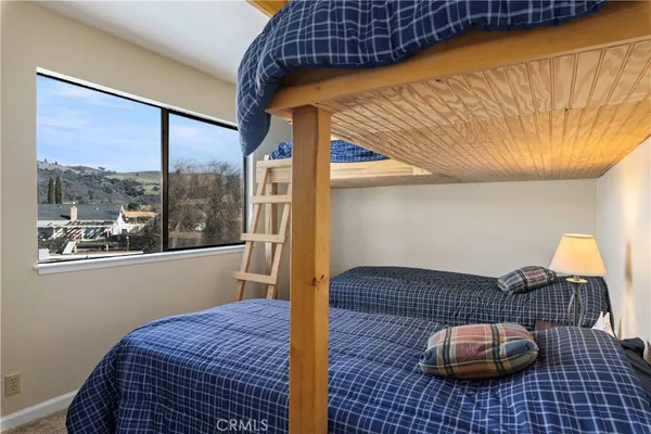 a view of room with wooden floor and flat screen tv