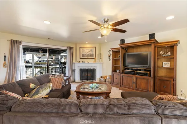 a living room with furniture and a flat screen tv with kitchen view