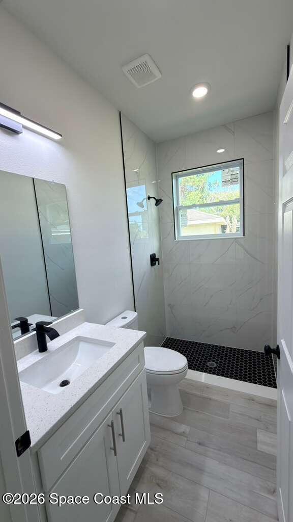 1091 Wing Road Southwest Palm Bay, FL 32908 - Photo 16 of 21 a bathroom with a sink a toilet a mirror and shower