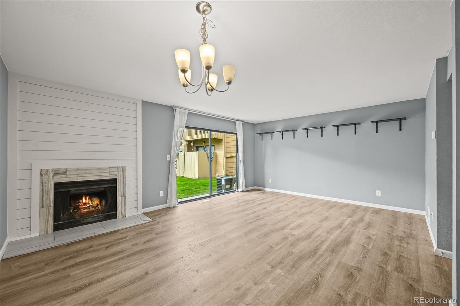 232 South Oman Road Castle Rock, CO 80104 - Photo 11 of 50 a view of an empty room with a fireplace and a window