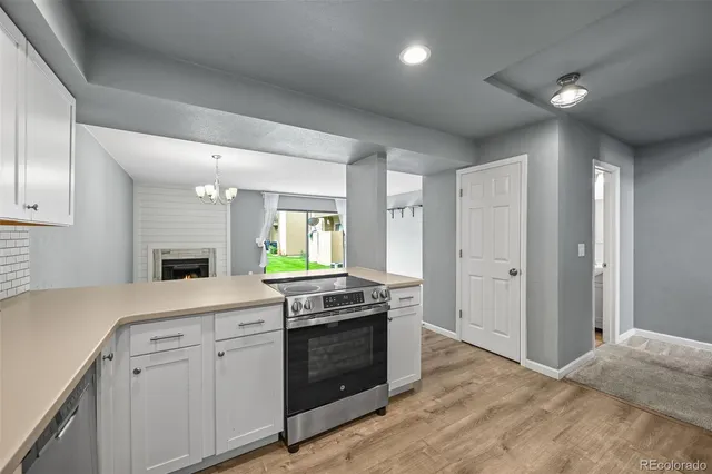 a view of a kitchen with furniture and wooden floor