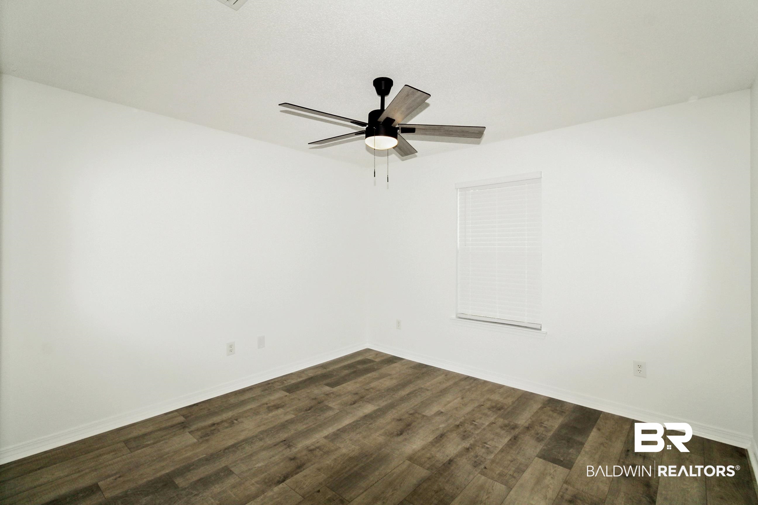 14750 Pawnee Court Foley, AL 36535 - Photo 28 of 34 Empty room featuring dark wood-style floors and a ceiling fan