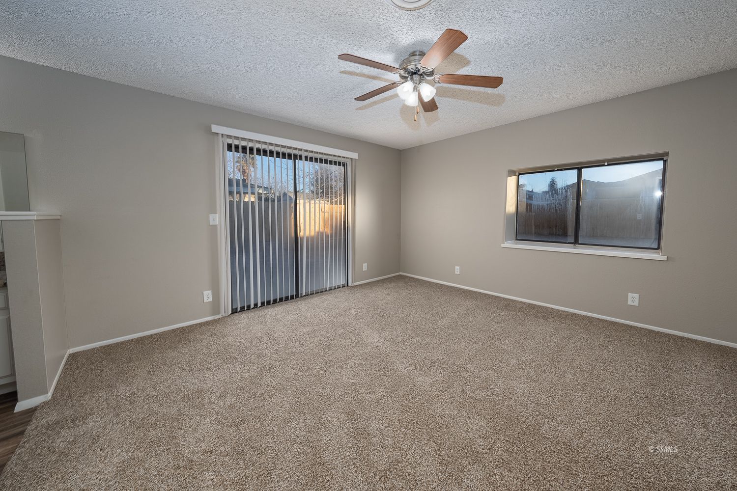 609 West Joyner Avenue Ridgecrest, CA 93555 - Photo 15 of 29 an empty room with chandelier fan and windows