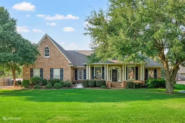 a front view of house with yard and green space