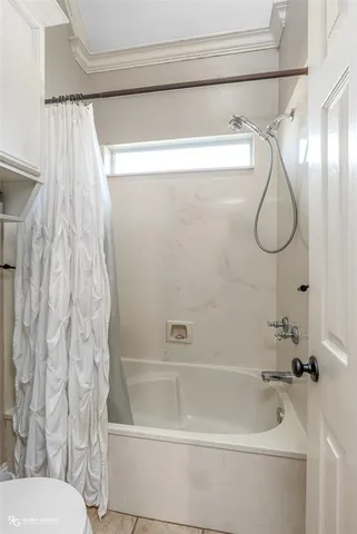 a bathroom with a shower and a toilet