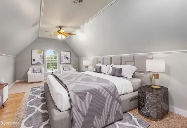 a bedroom with a bed couch chandelier and a window