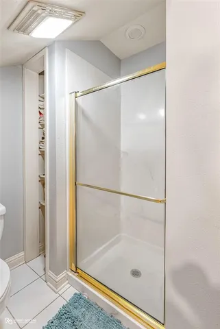 a bathroom with a glass shower door