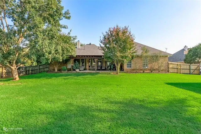 a view of green field with tree in the background