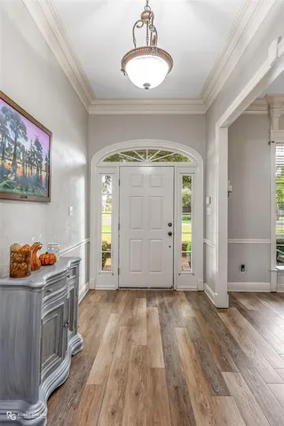 a view of a room with wooden floor and window