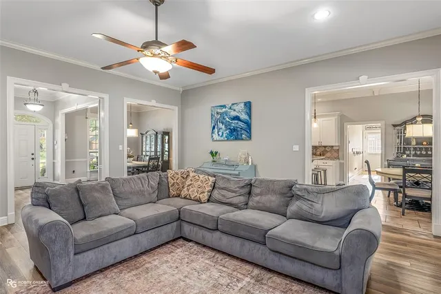 a living room with furniture and a chandelier