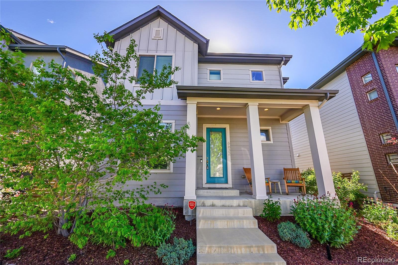 a front view of a house with plants