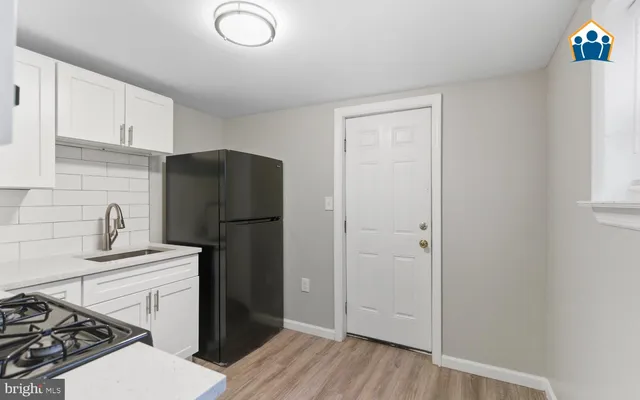 a kitchen with a refrigerator sink and stove