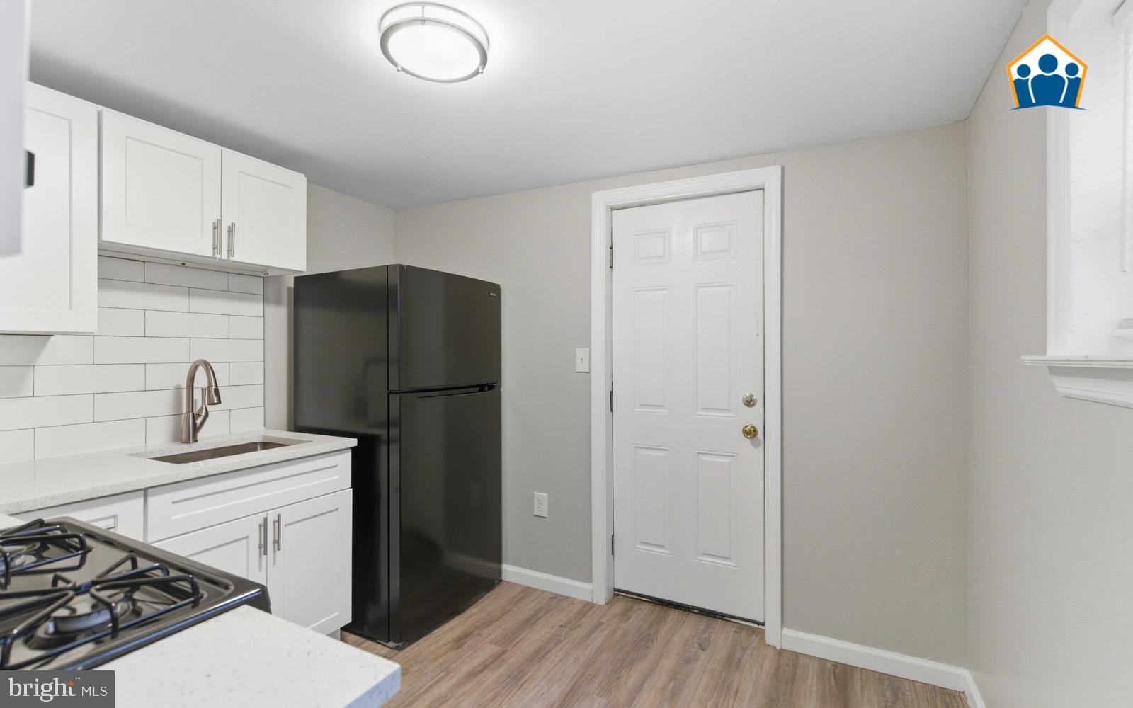 2528 Collins Street Philadelphia, PA 19125 - Photo 13 of 14 a kitchen with a refrigerator sink and stove
