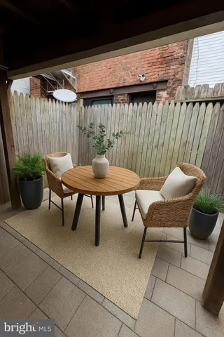 a view of a patio with a table and chairs