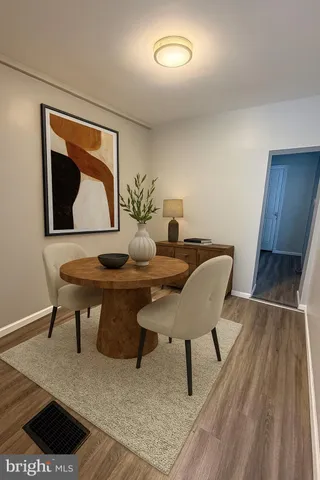 a dining room with furniture and wooden floor