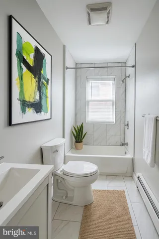 a bathroom with a bathtub toilet and sink