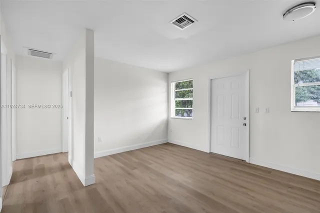 a kitchen with a refrigerator stove top oven and sink