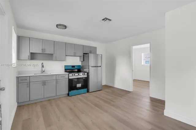a kitchen with stainless steel appliances granite countertop a stove and a refrigerator