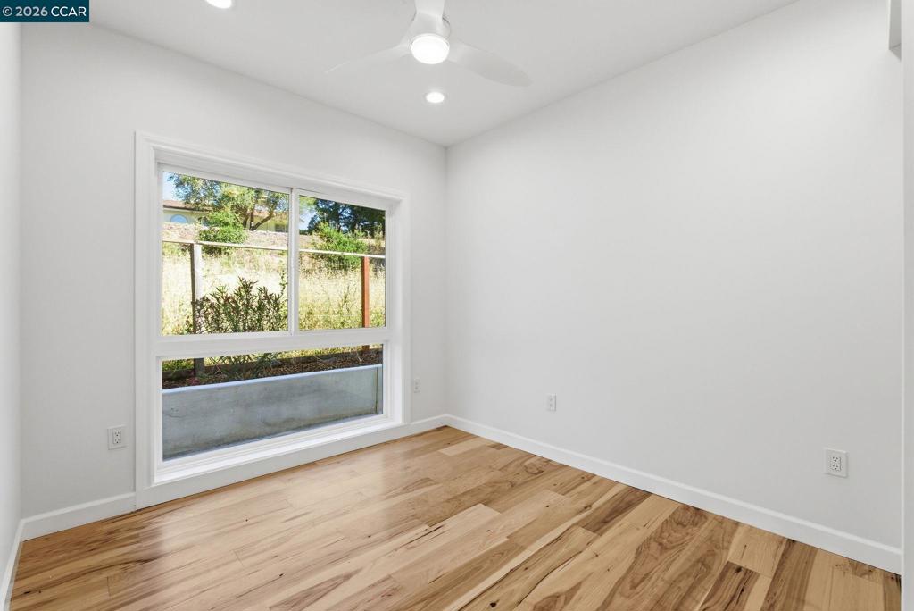 3196 Rohrer Drive Lafayette, CA 94549 - Photo 19 of 30 an empty room with wooden floor and windows