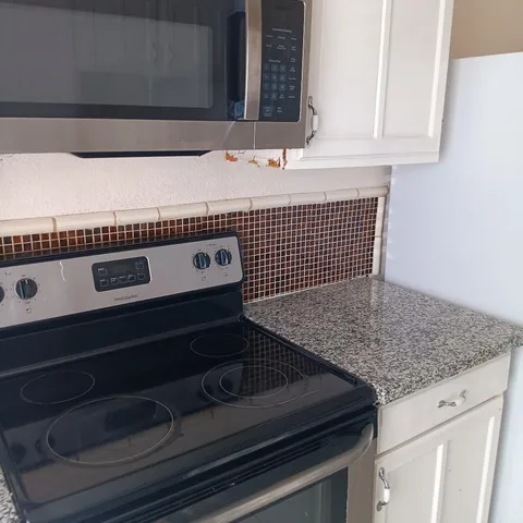 a kitchen with a refrigerator and countertop