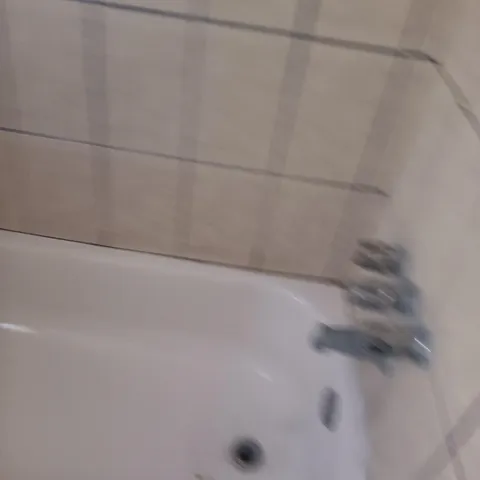 a bathroom with a granite countertop sink and a washing machine