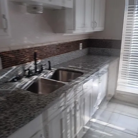 a kitchen with a sink and cabinets