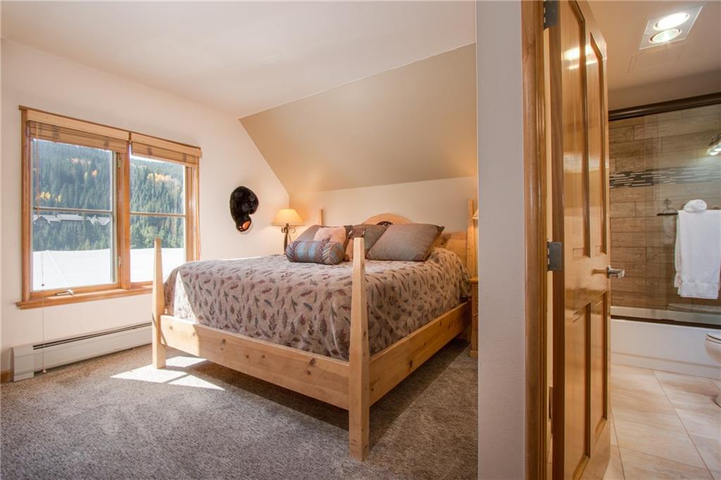 129 River Run Road, Unit 8061 Keystone, CO 80435 - Photo 6 of 19 a bedroom with a bed and a large window