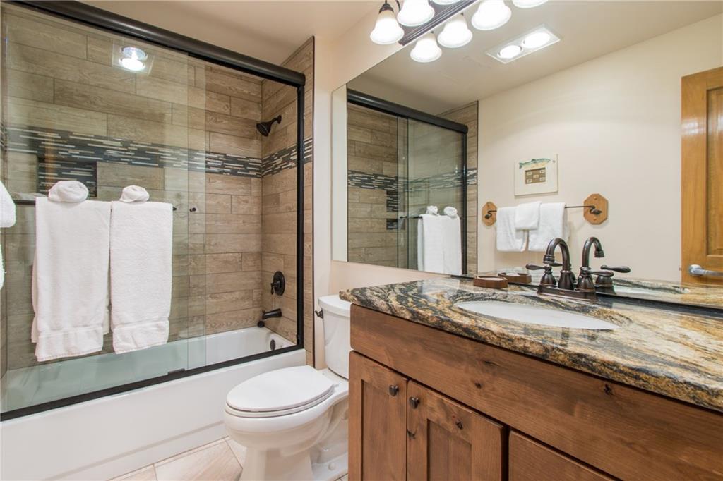 129 River Run Road, Unit 8061 Keystone, CO 80435 - Photo 8 of 19 a bathroom with a granite countertop sink toilet and shower