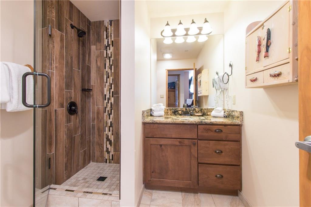 129 River Run Road, Unit 8061 Keystone, CO 80435 - Photo 9 of 19 a bathroom with a double vanity sink mirror and shower