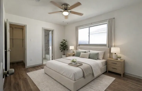 a bedroom with a large bed and a chandelier