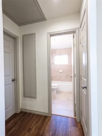 a view of empty room with wooden floor