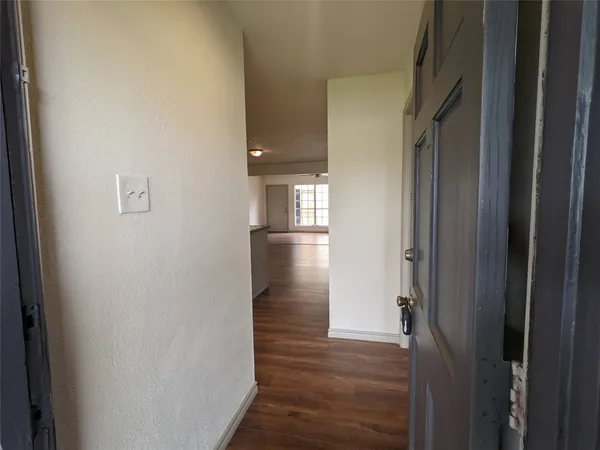 a view of hallway with wooden floor