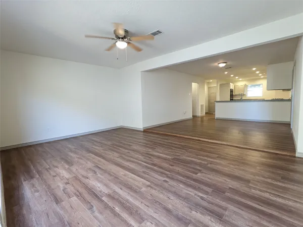 a view of an empty room and wooden floor