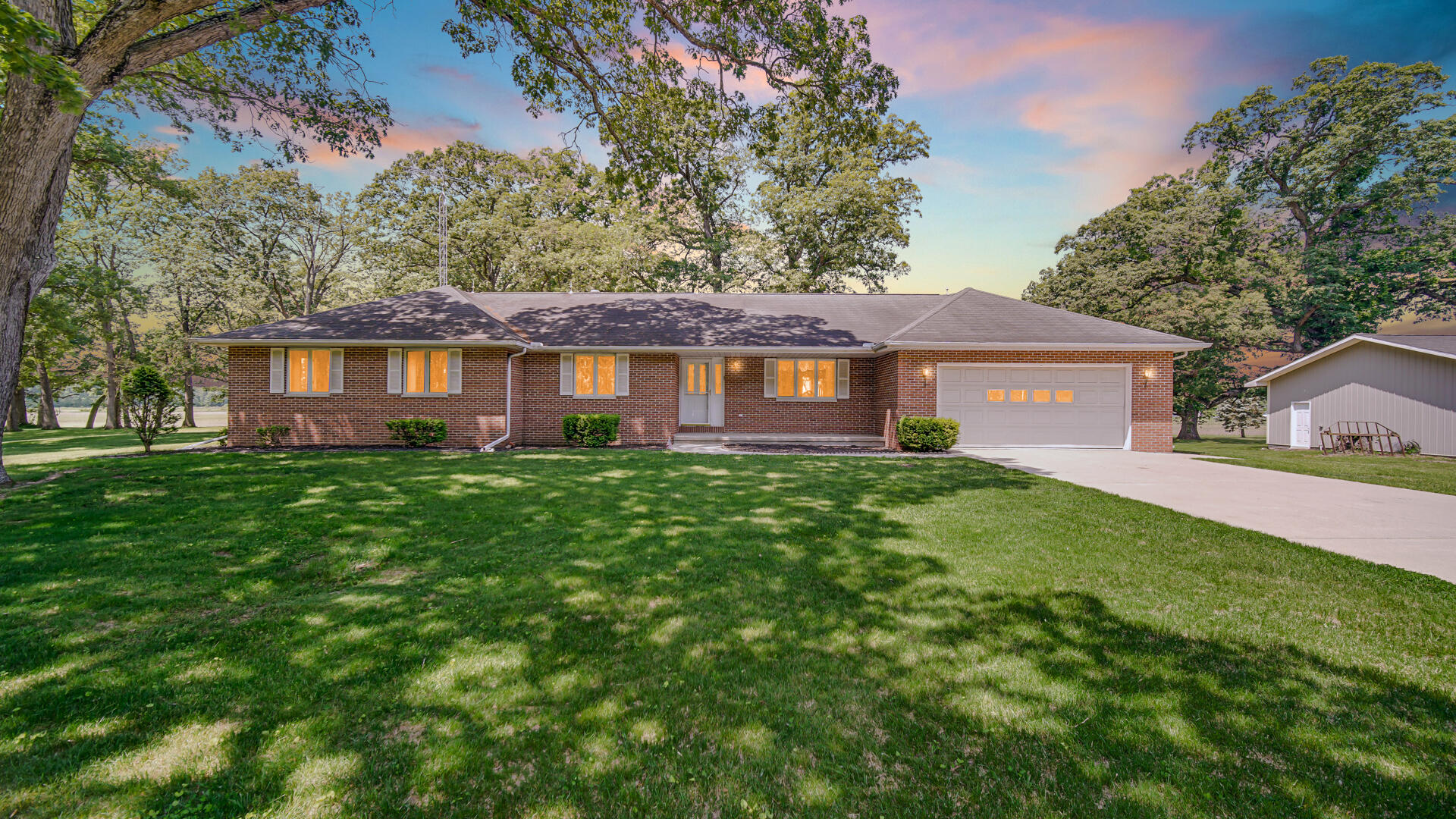 a front view of house with yard and green space