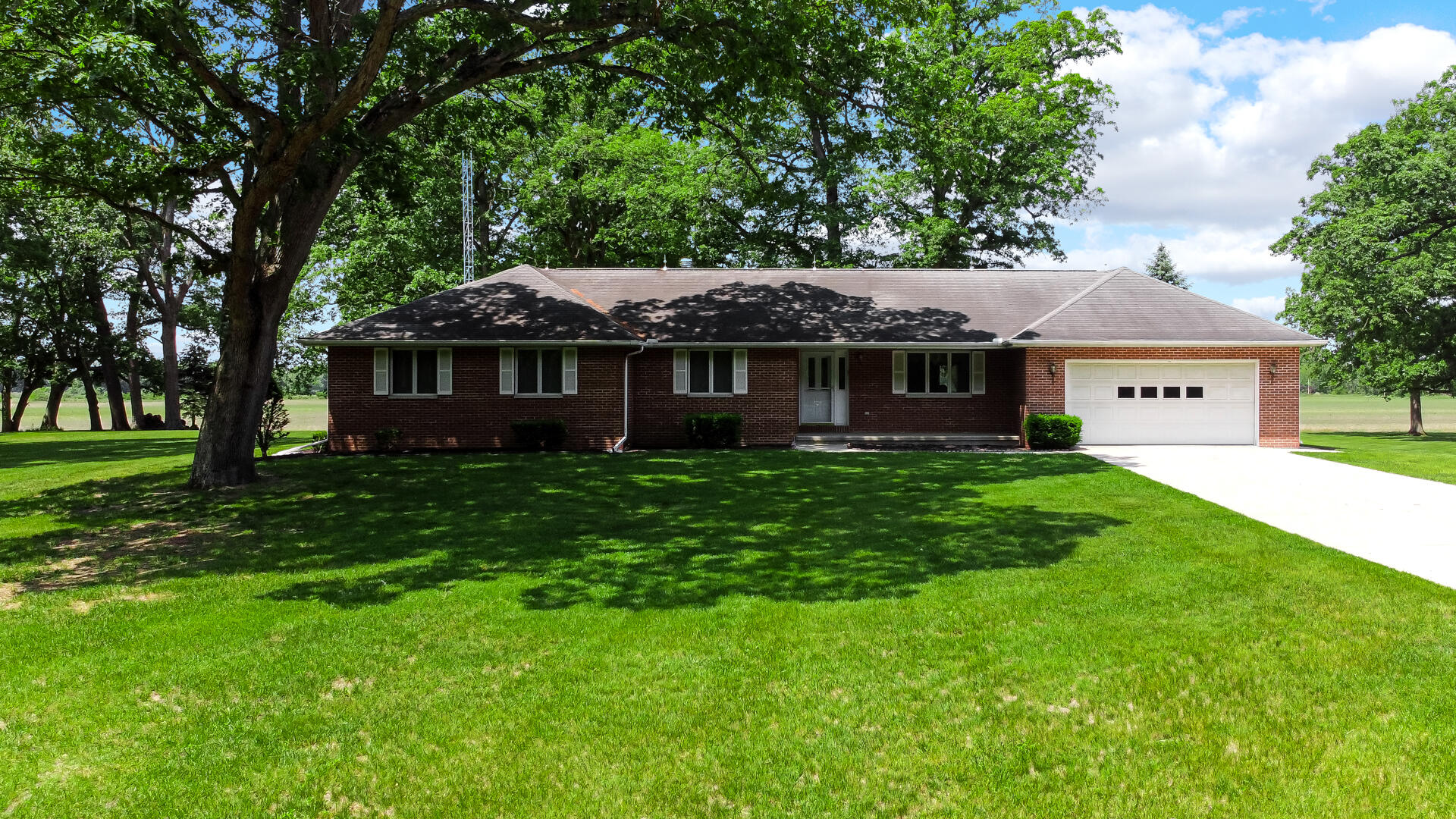 8135 South 600 East Monterey, IN 46960 - Photo 2 of 34 a front view of a house with a garden