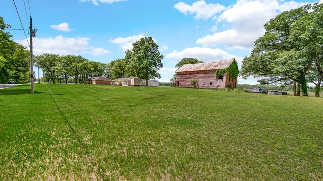 a front view of house with yard and trees