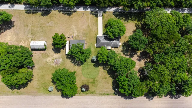 an aerial view of residential house with outdoor space and lake view
