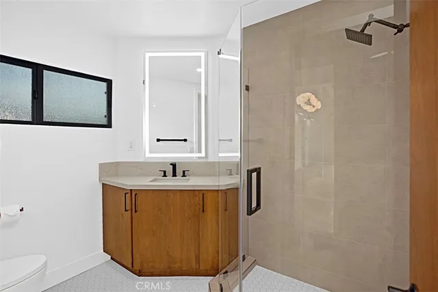 a bathroom with a sink a toilet and mirror