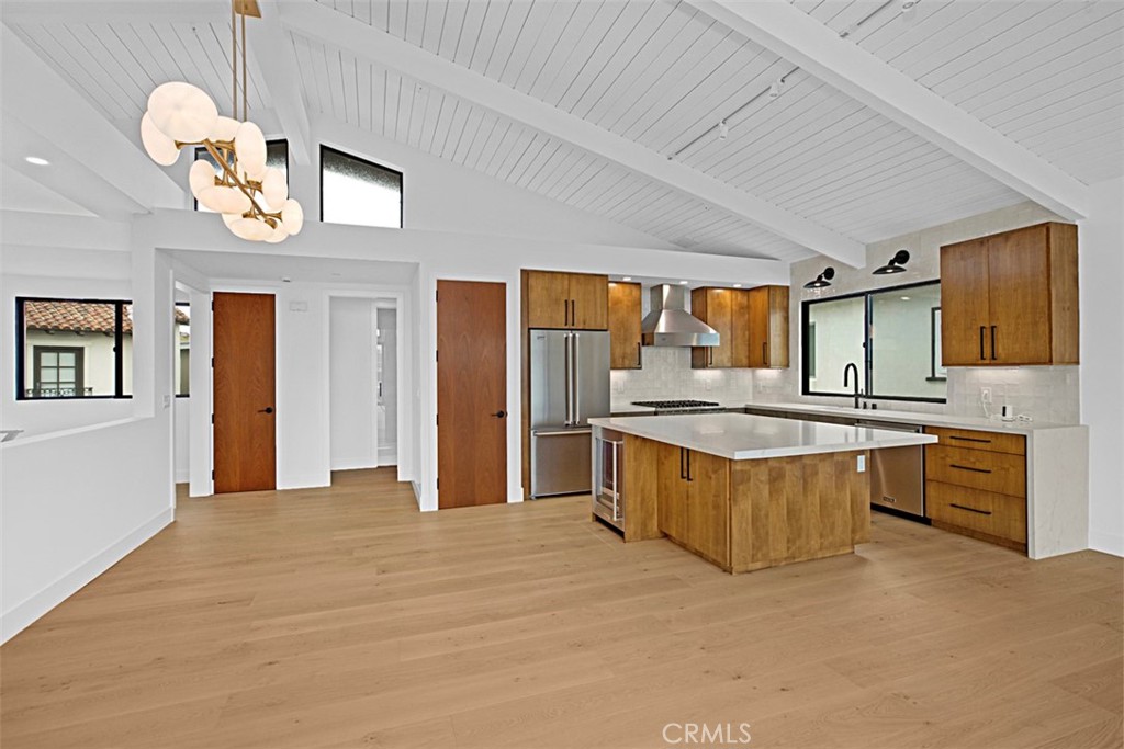 4017 Channel, Unit B Newport Beach, CA 92663 - Photo 5 of 18 a large kitchen with stainless steel appliances granite countertop a stove a sink dishwasher and a refrigerator with wooden floor