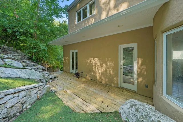 a view of a bedroom with backyard and wooden fence
