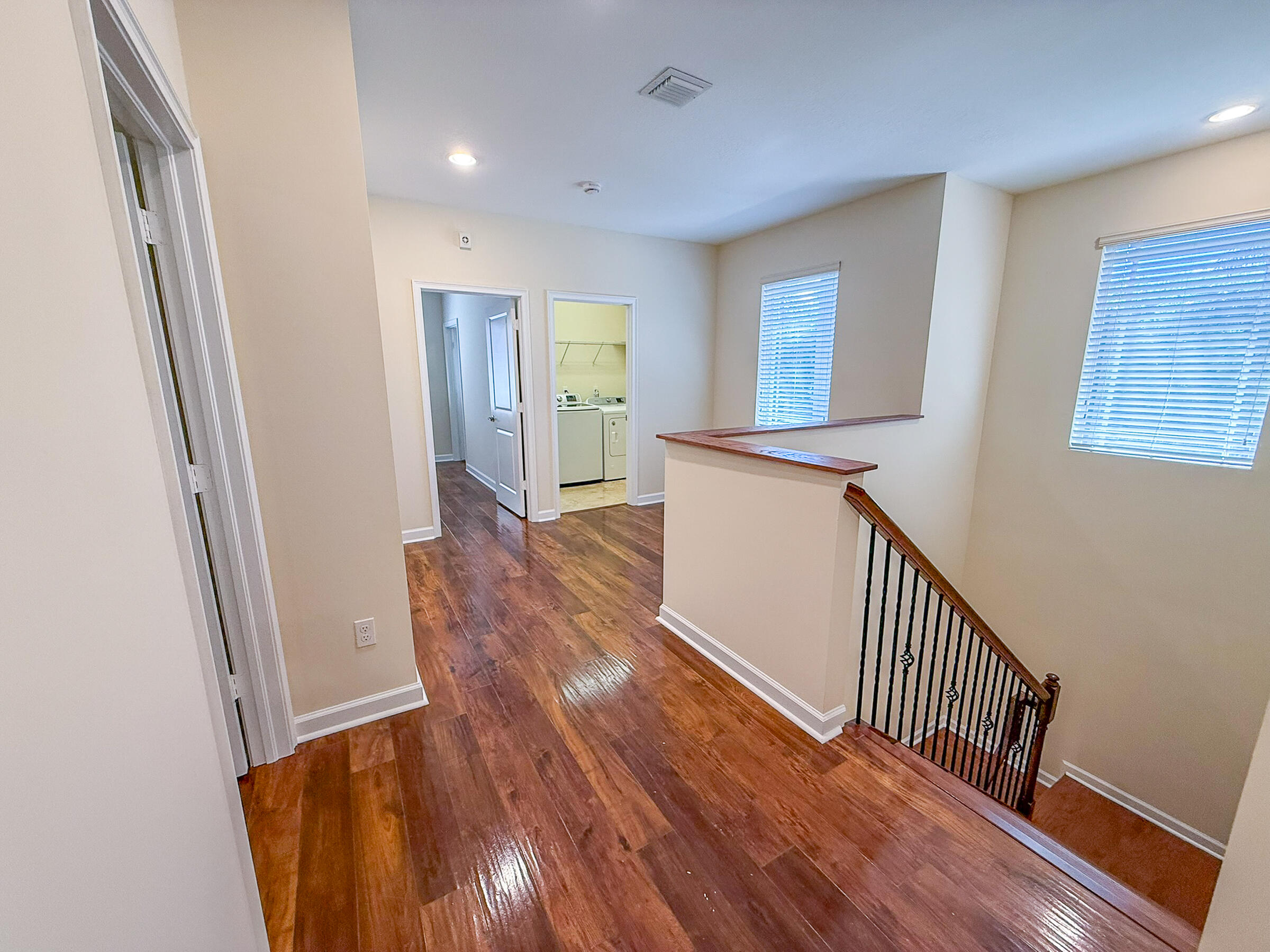 122 Northwest Gardner Street Boca Raton, FL 33432 - Photo 12 of 34 a view of a hallway with wooden floor and staircase